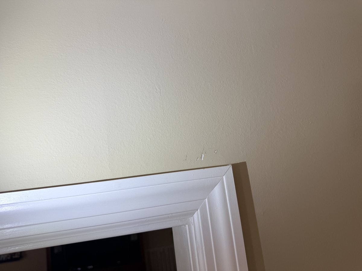 Damaged paint above a door casing