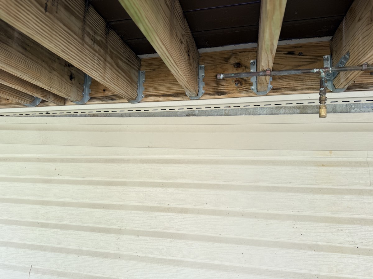 Missing siding piece under a deck