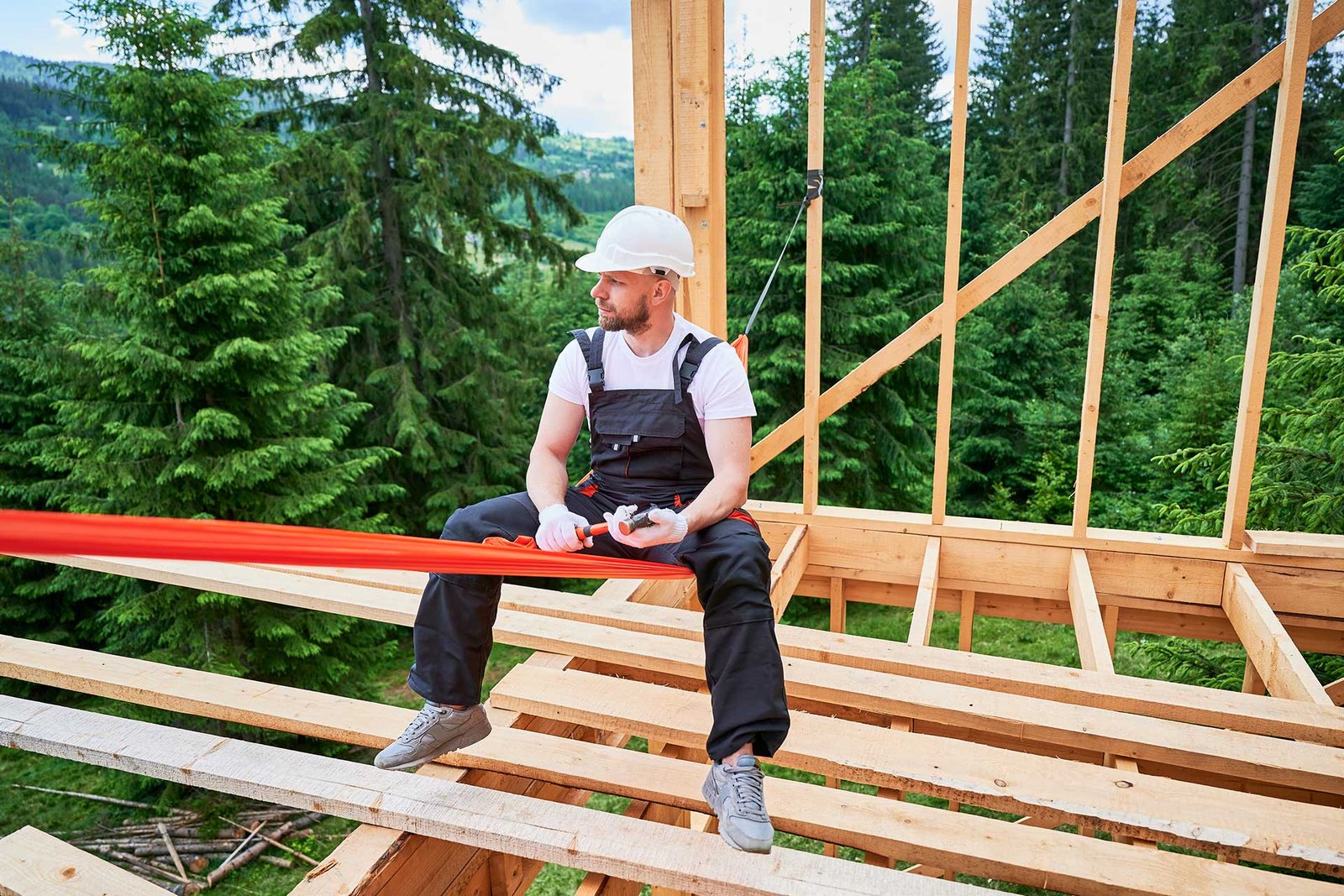 Construction worker installing electrical conduit outdoors